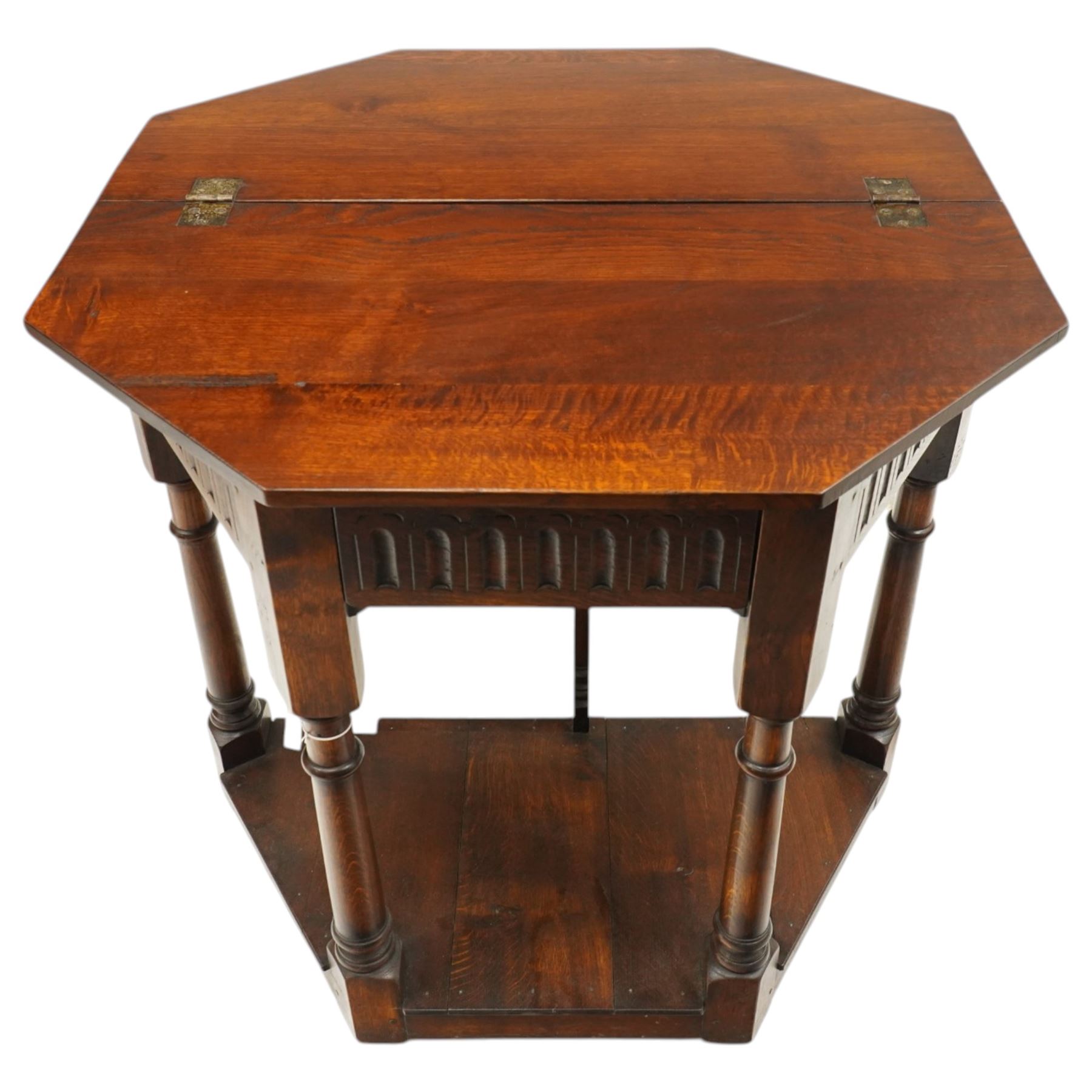 Gothic Revival oak fold-over console table, of octagonal form when unfolded, carved frieze with full length undertier 