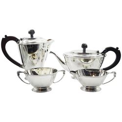 1930's four piece silver tea service, comprising teapot, hot water pot, twin handled open sucrier, and milk jug, each of plain oval form upon a stepped oval foot, the teapot and hot water pot with  brown Bakelite handles and finials, hallmarked William Neale & Son Ltd, Birmingham 1938 and 1939, approximate gross weight 49.76 ozt (1547.9 grams)

