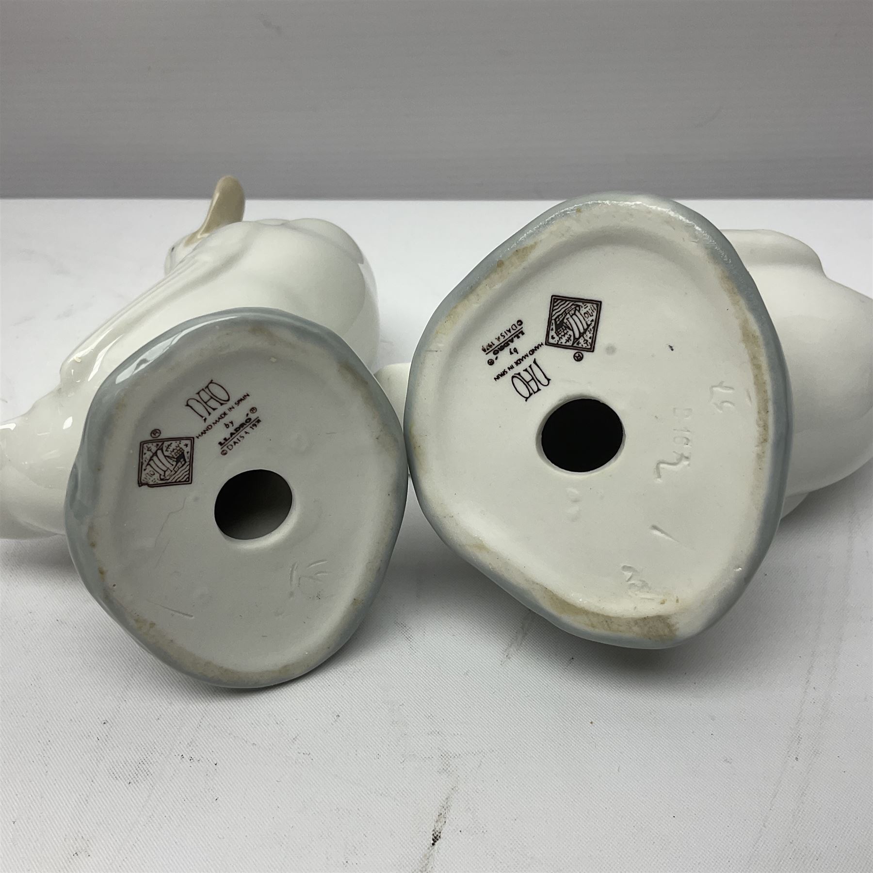 Two Lladro figures, Over the Threshold no 5282 and Prayful Moment no 5500 together with five Nao figures