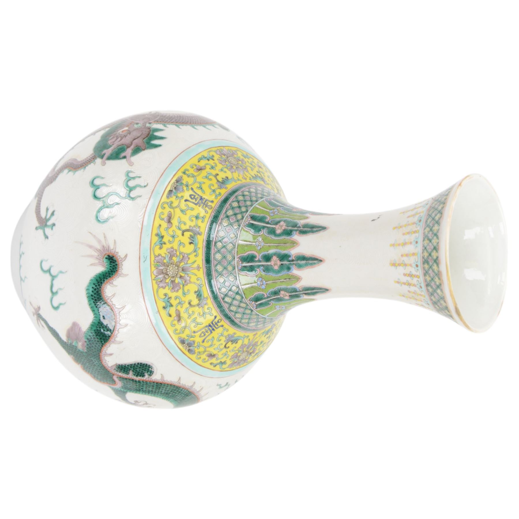 Pair 20th century Chinese famille verte bottle vases, each decorated with green and purple dragons chasing pearls amidst auspicious flames, the neck with yellow and green stylised foliate and cell borders, and the white glazed body incised throughout with fan shapes, each with red character mark beneath flanked by green dragons, H38cm

