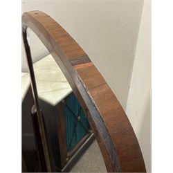 Early 19th century mahogany cheval dressing mirror, plain mirror plate within chamfered frame with arched top, on rolled horns and out-splayed rolled feet, united by turned stretcher 