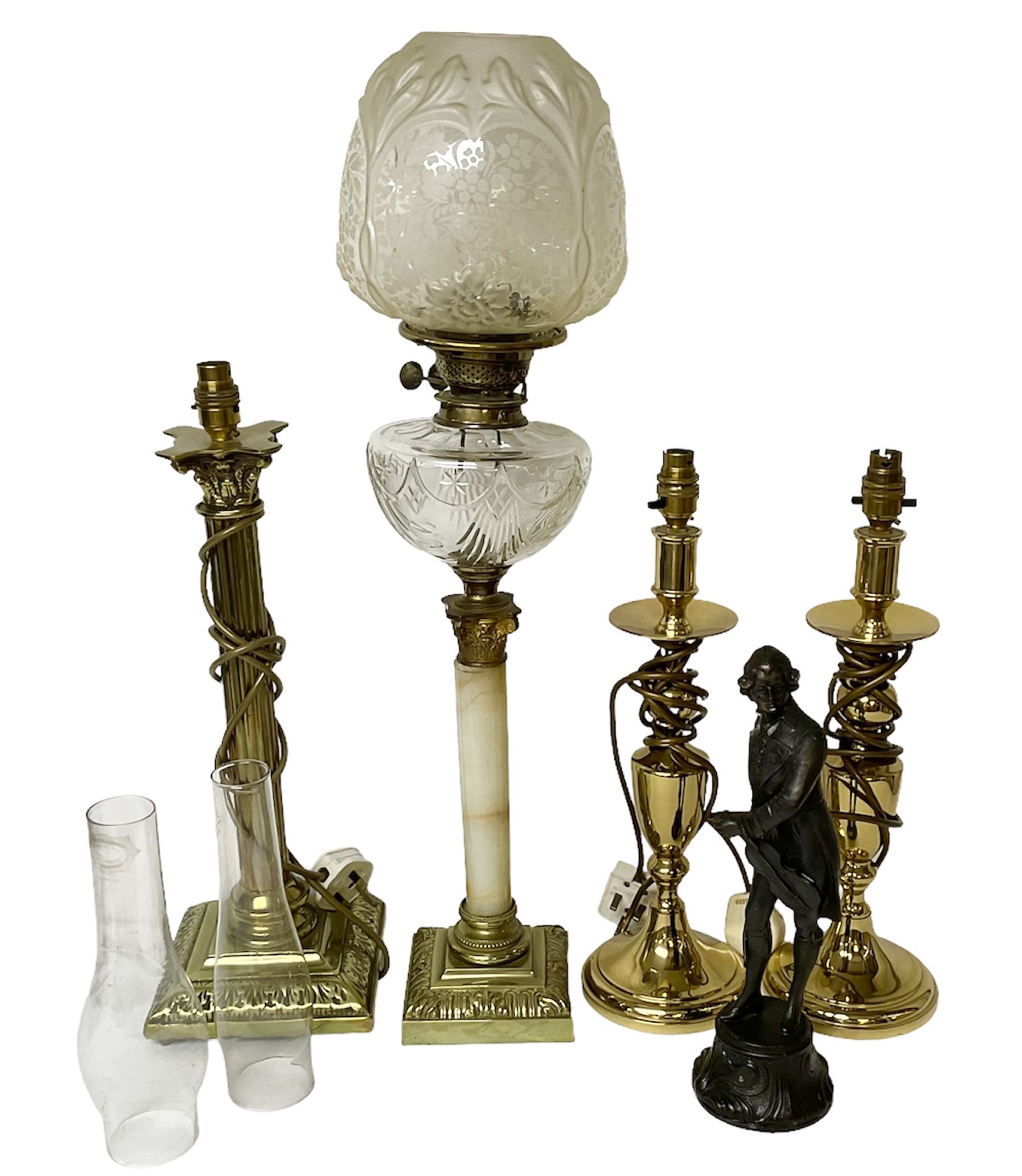 Oil lamp with frosted floral shade and cut glass reservoir, upon cast brass and marble base, together with a cast brass Corinthian column table lamp, pair of brass table lamps and a composite metal figure of a violinist 
