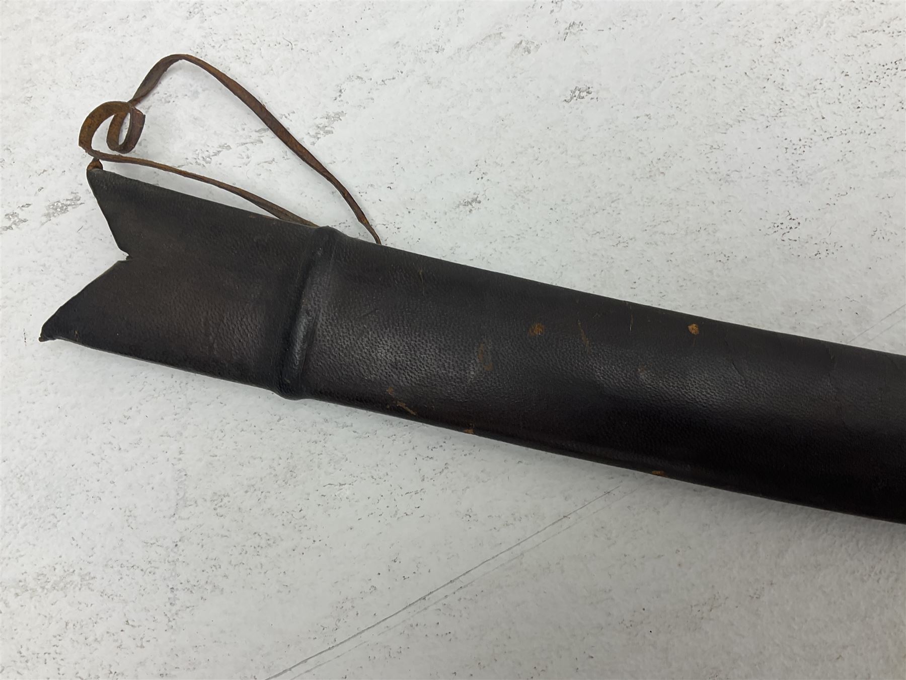 Late 19th/early 20th century Indian Tulwar sword with 81cm plain curving steel blade and iron hilt with extended langets, knucklebow and spiked pommel; in leather covered scabbard L100cm overall; and another Tulwar lacking scabbard in almost relic condition (2)