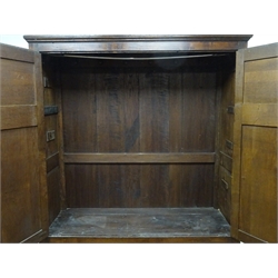  George lll oak press cupboard enclosed by a pair of twin raised and fielded panel doors, interio with fitted hooks, above two drawers with panel sides on stile feet, W158cm, H194cm, D64cm  