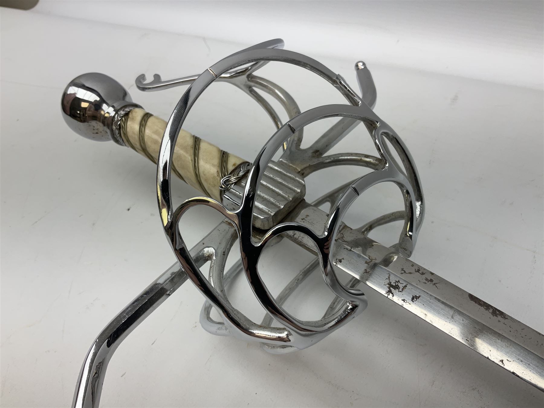 Replica knight's longsword, the 91.5cm double-edged steel blade with basket hilt and wire-bound bone grip with spherical pommel, in leather scabbard L112cm overall