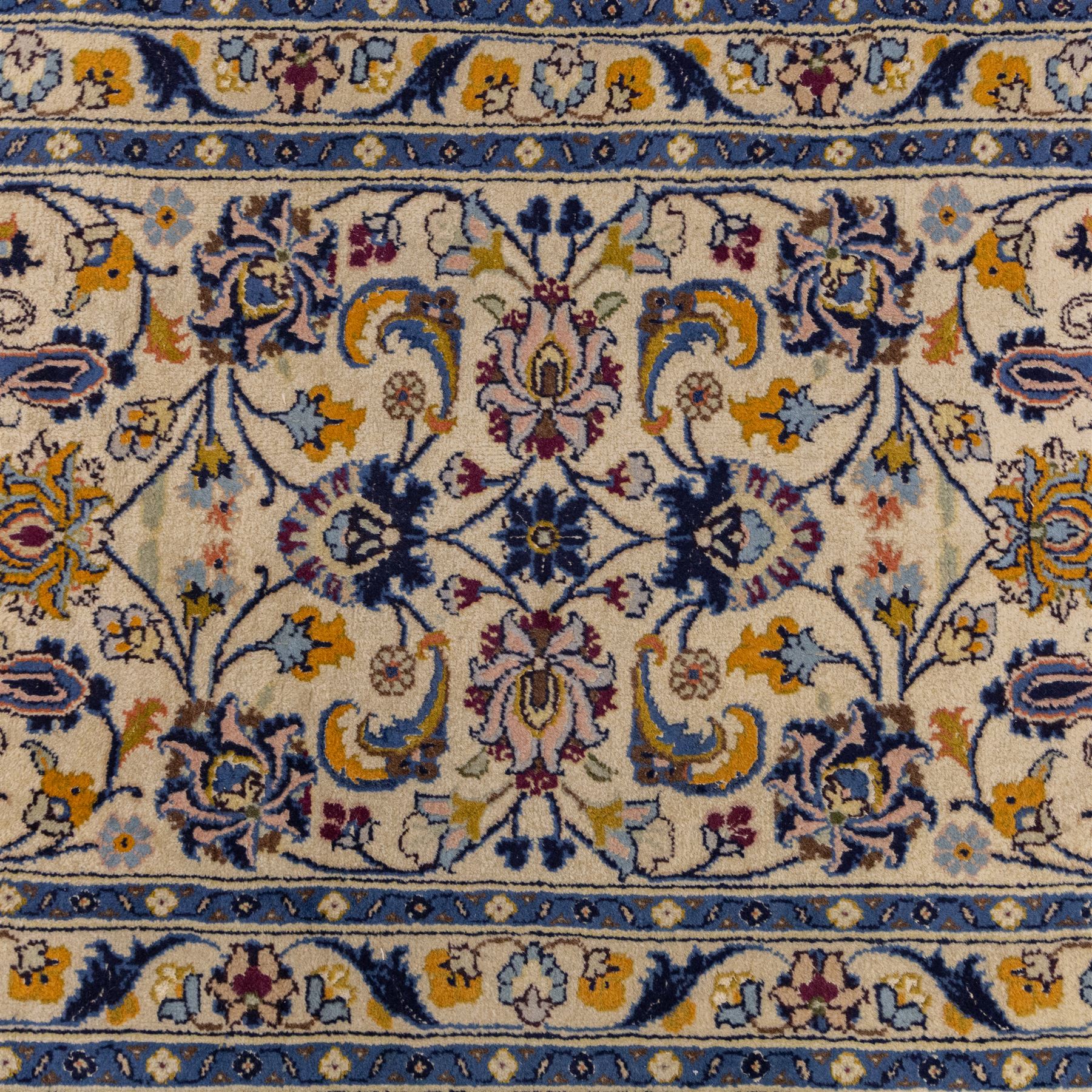 Central Persian Kashan hand-knotted runner, ivory field decorated with an elegant all-over scrolling vine design composed of finely drawn palmettes, floral strays and arabesques in a continuous lattice, principal border on an indigo ground decorated with palmette and vine scroll, flanked by multiple narrow guard stripes, with cotton fringe ends 
