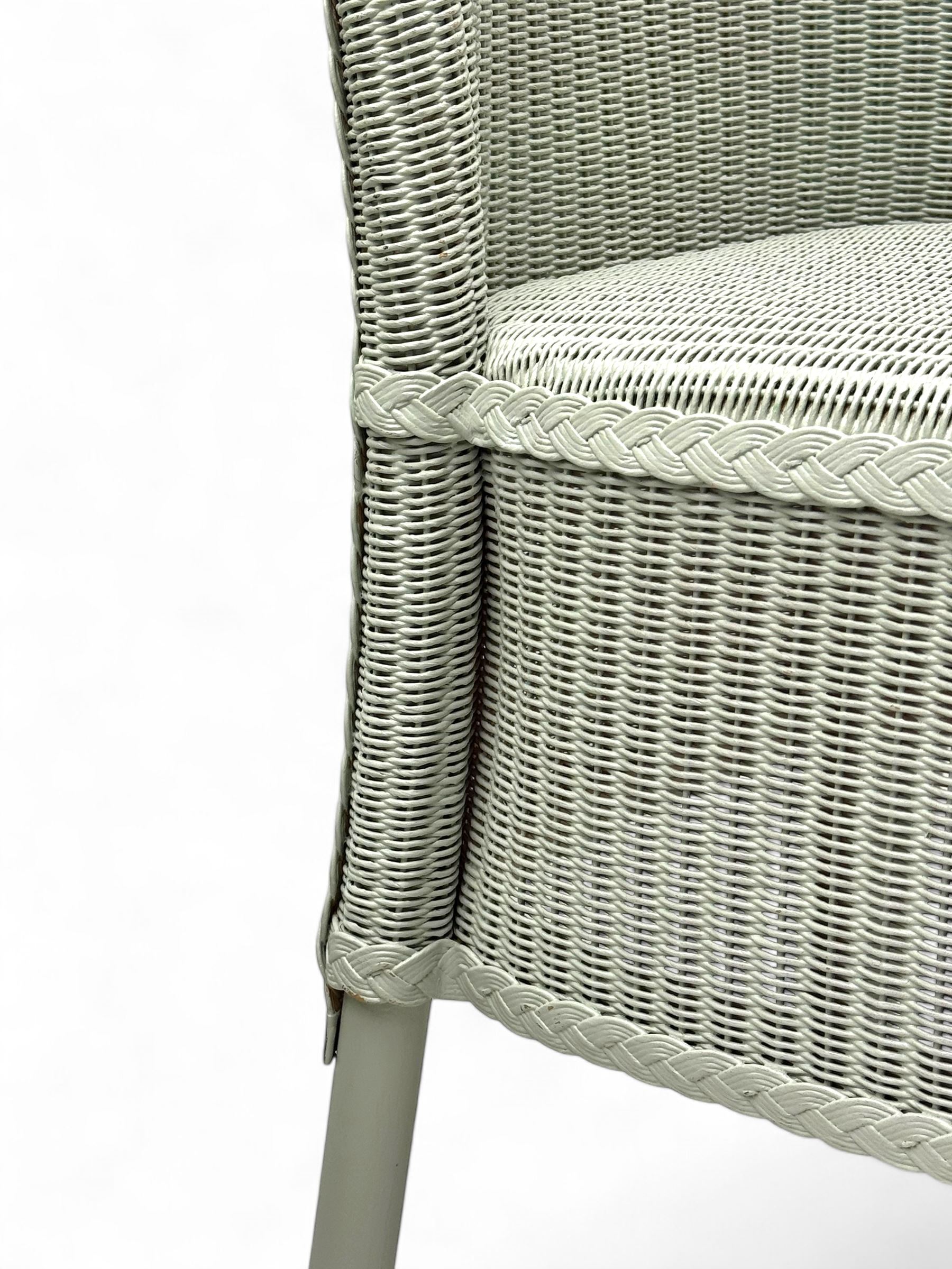 Set of four Lloyd Loom dining chairs, each with woven high back and seat in sage green finish, raised on matching painted tubular supports