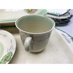 Clarice Cliff for Newport Pottery Corolla pattern tea and dinner wares, comprising triangular bowl, four side plates, two shallow bowls and teacup (a/f), together with a Clarice Cliff Wilkinson twin handled soup bowl and unassociated saucer both decorated with pink and yellow flowers, together with other mid century ceramics comprising Parrott and Company Coronet Ware, and Royal Staffordshire AJ. Wilkinson Ltd dinner wares