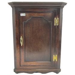George III oak wall hanging corner cupboard, projected cornice over crossbanded and fielded panelled door, enclosing three shelves