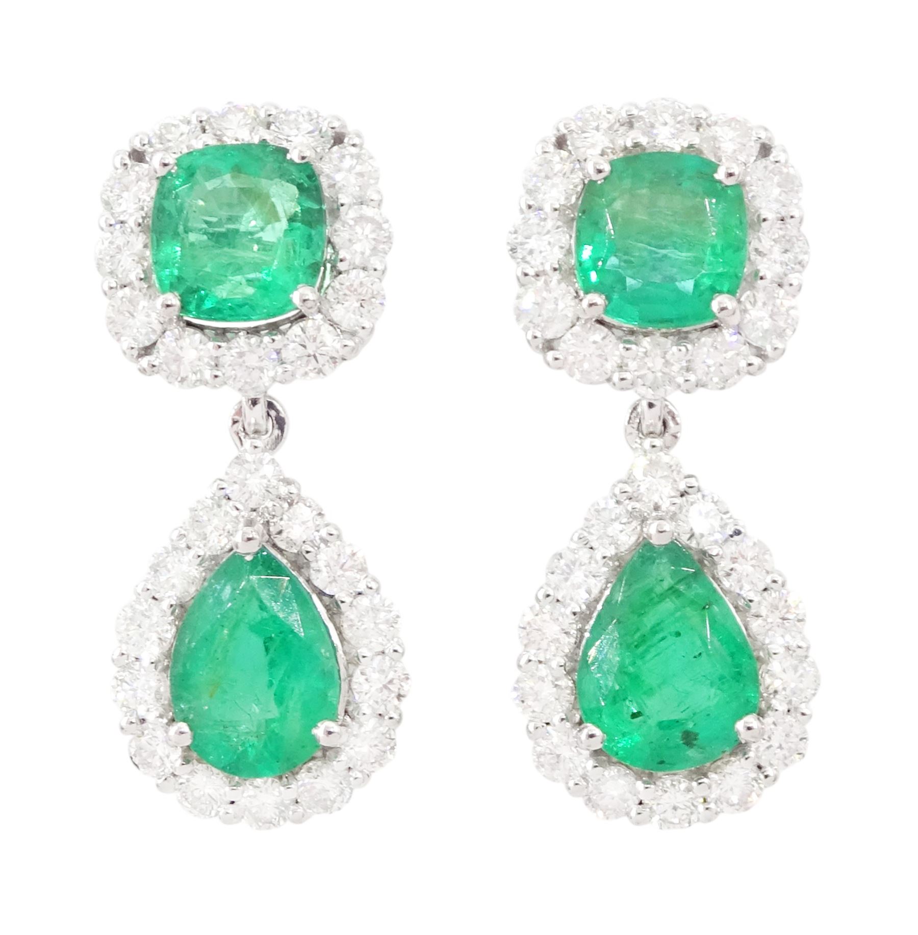 Pair of 18ct white gold emerald and diamond pendant earrings, each stud set with a cushion cut emerald and round brilliant cut diamond surround, suspending a further pear cut emerald and diamond cluster stamped, total emerald weight approx 3.45 carat, total diamond weight approx 1.70 carat