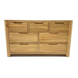 Light oak chest fitted with three short drawers above four long drawers, raised on stile supports 