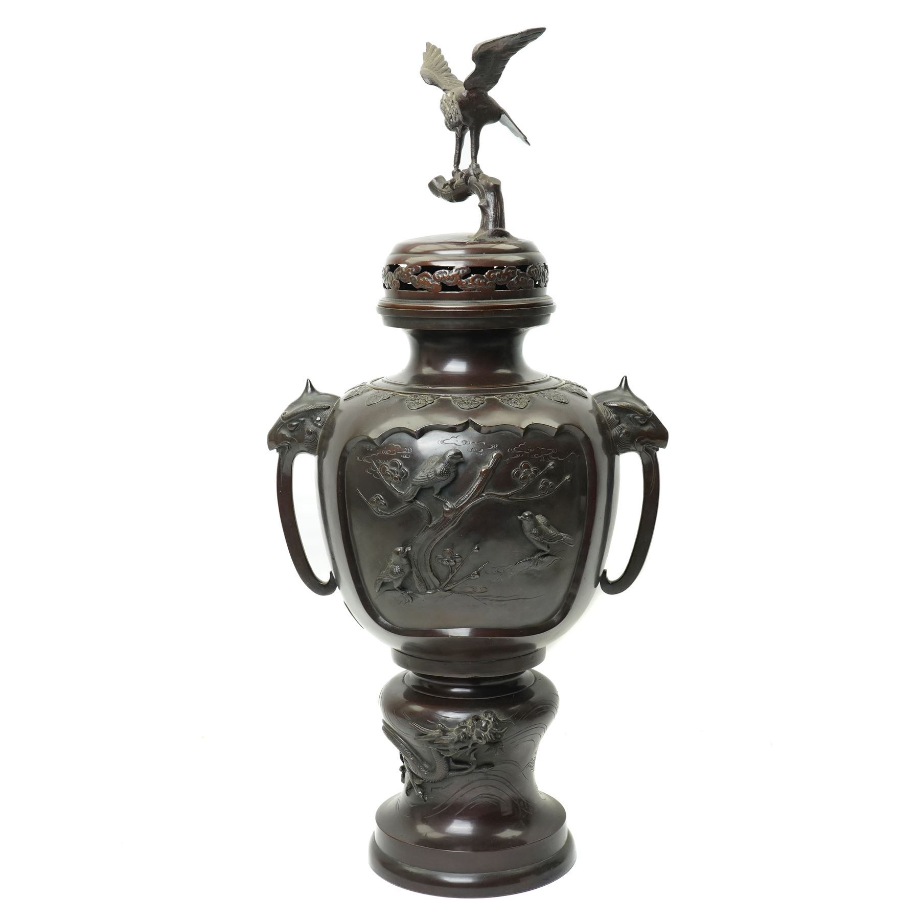 Japanese late Meiji period bronze koro and cover, surmounted by an eagle finial and with bird decoration in high relief to each side, twin elephant trunk handles, bearing indistinct character signature to one side, H82cm
