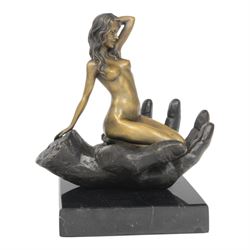Nude In Hand bronze sculpture modeled as a female nude seated in a hand upon a marble base...