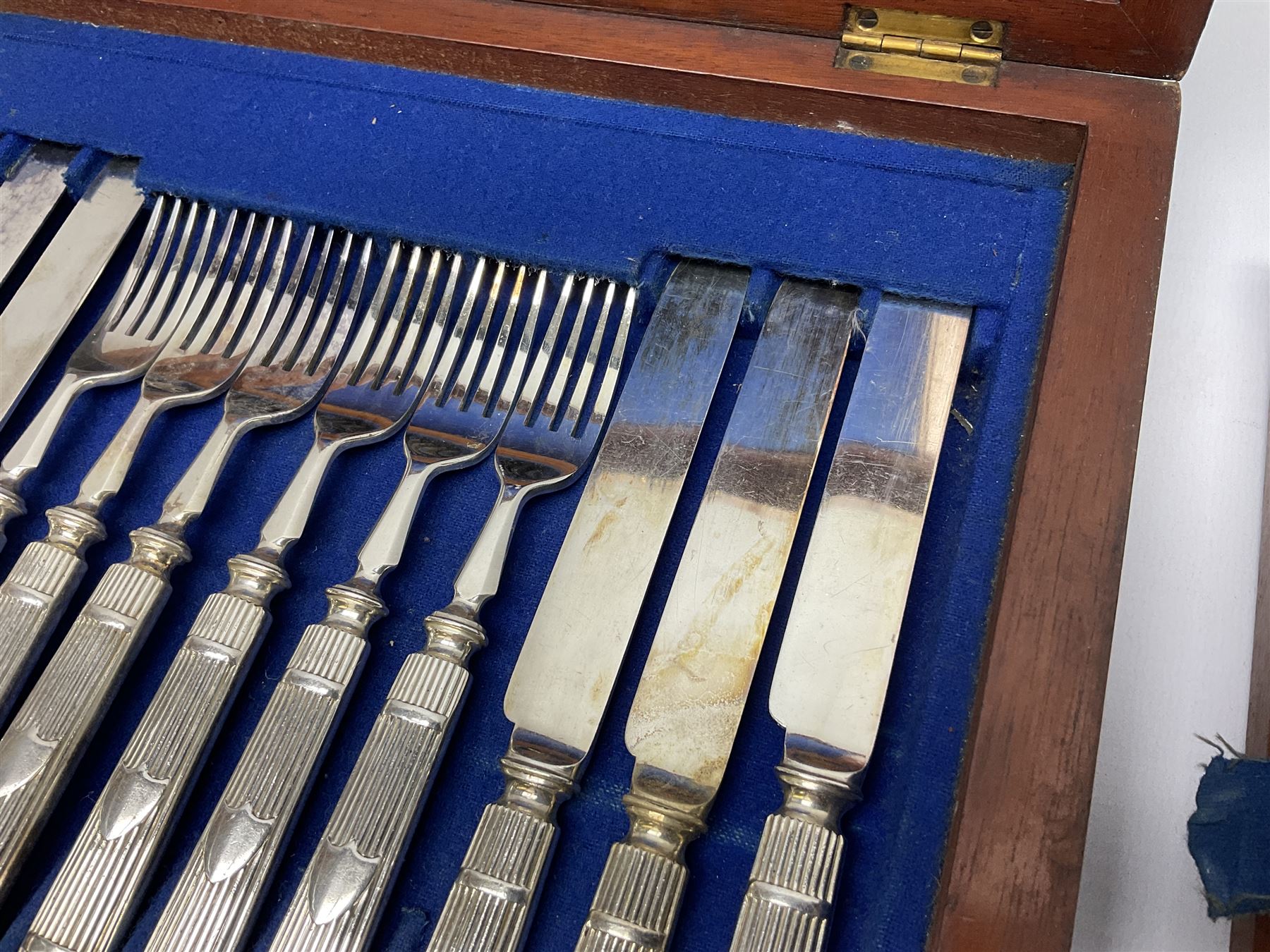 Victorian silver plated dessert set by Elkington & Co for twelve place settings, each reeded handle with vacant cartouche, each with Elkington & Co mark, date letter for 1861, and registration lozenge, contained within a mahogany case with vacant brass cartouche to the hinged cover, opening to reveal a Royal blue baize lined interior with removable tray, case H6cm W29.5cm D26.5cm