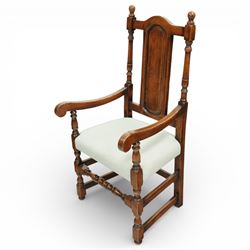 Country House oak high back dining chairs, set of ten comprising eight side chairs and two carvers, each with arched top rail flanked by turned finials over a central fielded panel back, with overstuffed seats upholstered in pale fabric, raised on turned front supports united by stretchers
