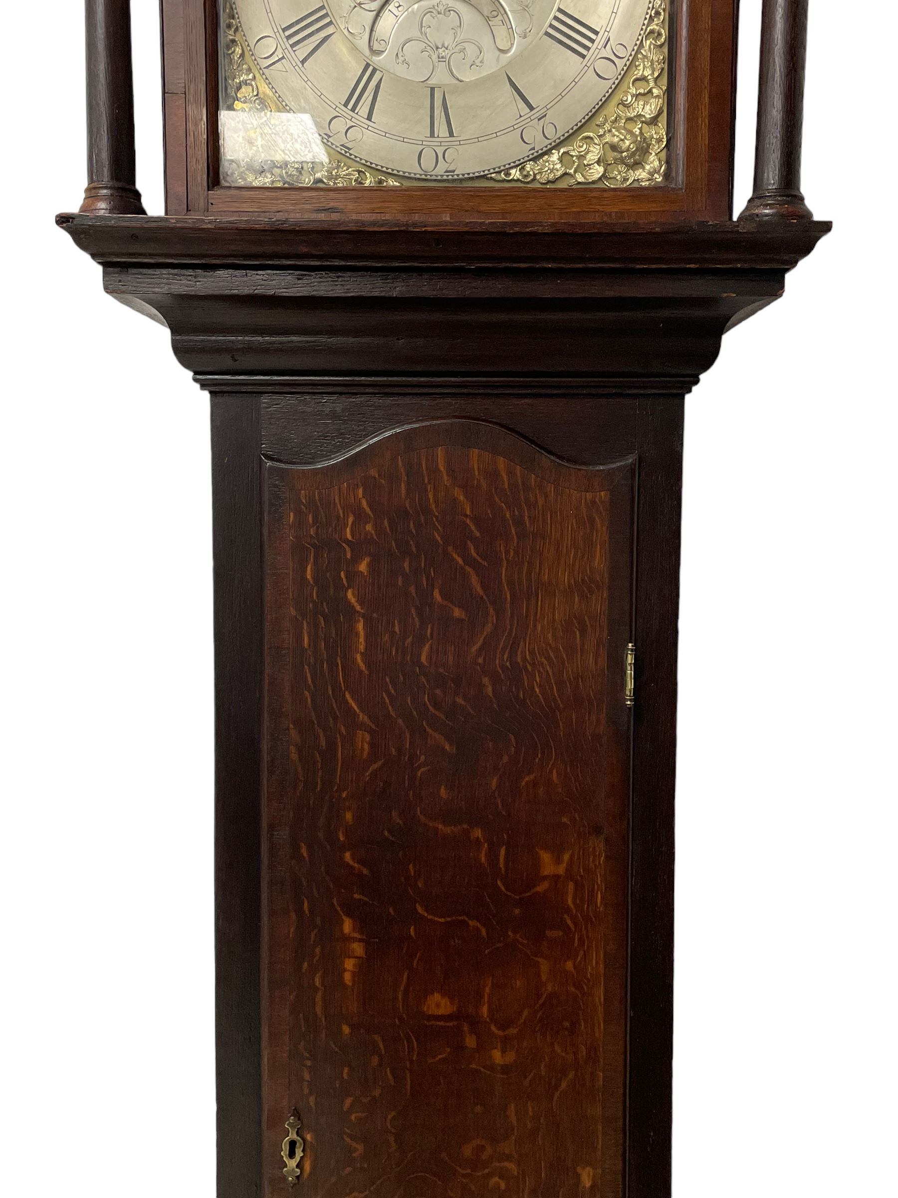 Thomas Hutchinson of Leeds - 18th century 8-day oak longcase clock with as broken arched  pediment and moulded cornice, with a conforming hood door flanked by plain turned pilasters with gesso capitals,  long trunk door with a wavy top on a square plinth with a raised panel, brass dial with cast spandrels,  engraved silvered dial centre and chapter ring with Roman numerals, five minute Arabic's and minute track, with pierced steel hands, seconds pointer,  arched calendar aperture and silvered boss engraved with the makers name to the break arch, dial pinned to a rack striking two train movement with a recoil anchor escapement. With weights and pendulum. Thomas Hutchinson is recorded as working in Leeds from 1760-90.