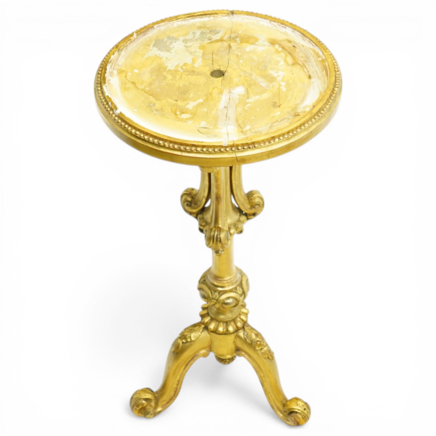 Late 19th century giltwood torchère stand, circular top with beaded moulded edge, on a turned and carved column with scrolling acanthus detail, raised on three cabriole supports with leaf carving and scroll feet
