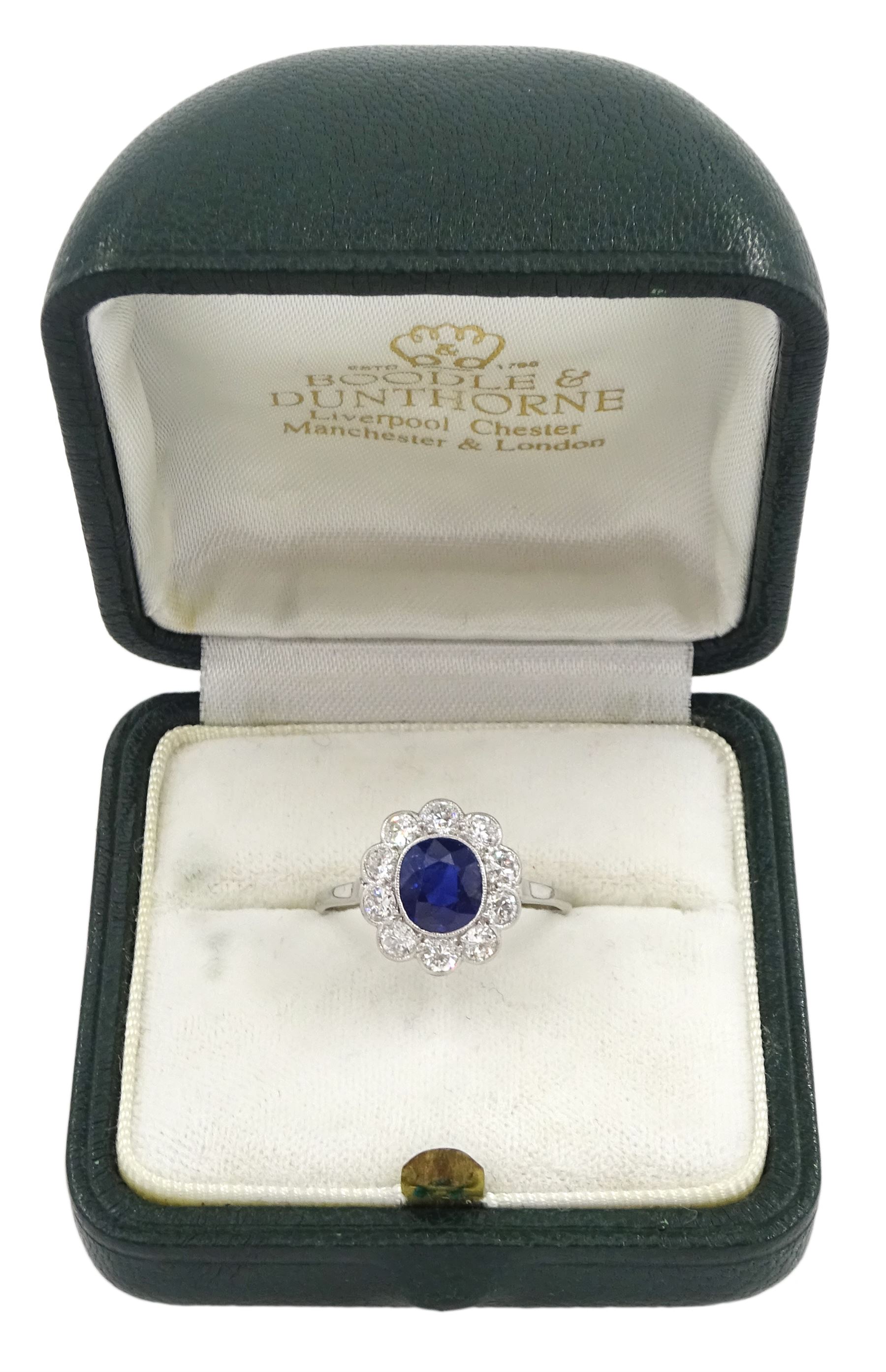 Palladium and platinum milgrain set oval sapphire and diamond cluster ring, sapphire approx 1.35 carat, total diamond weight approx 0.55 carat