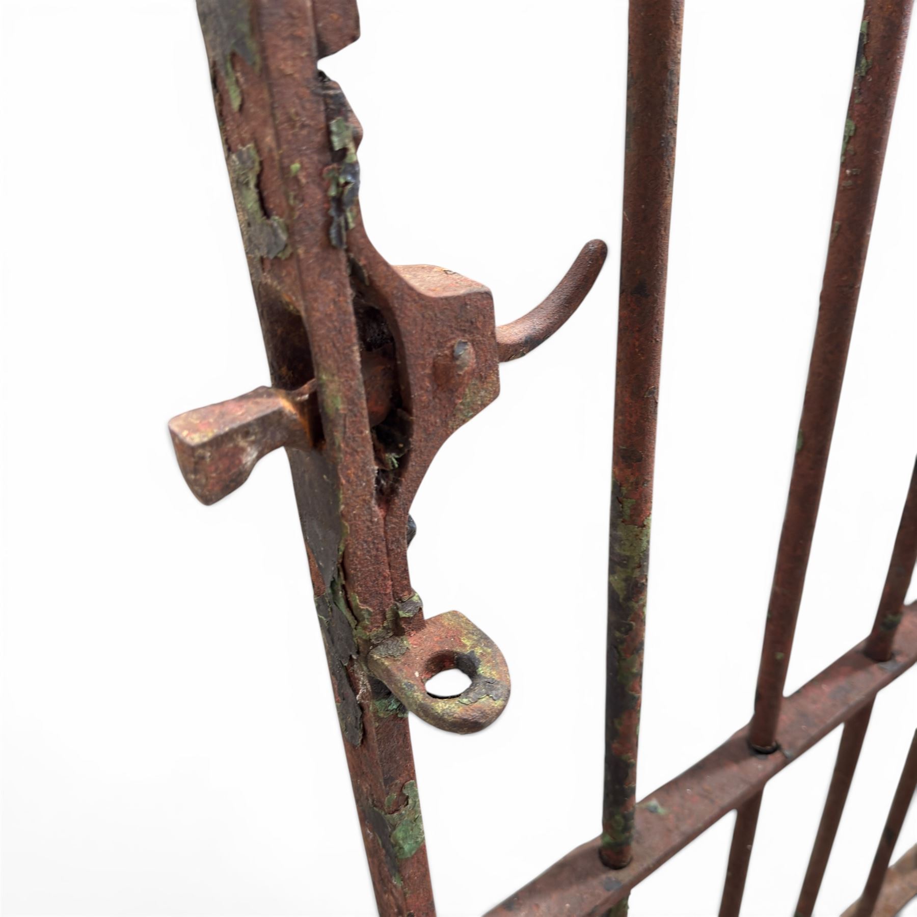 Georgian wrought iron single garden gate, pointed finial over strapwork cresting rail and arched profile with spearhead finials, the opposing side with scrollwork and hinged latch