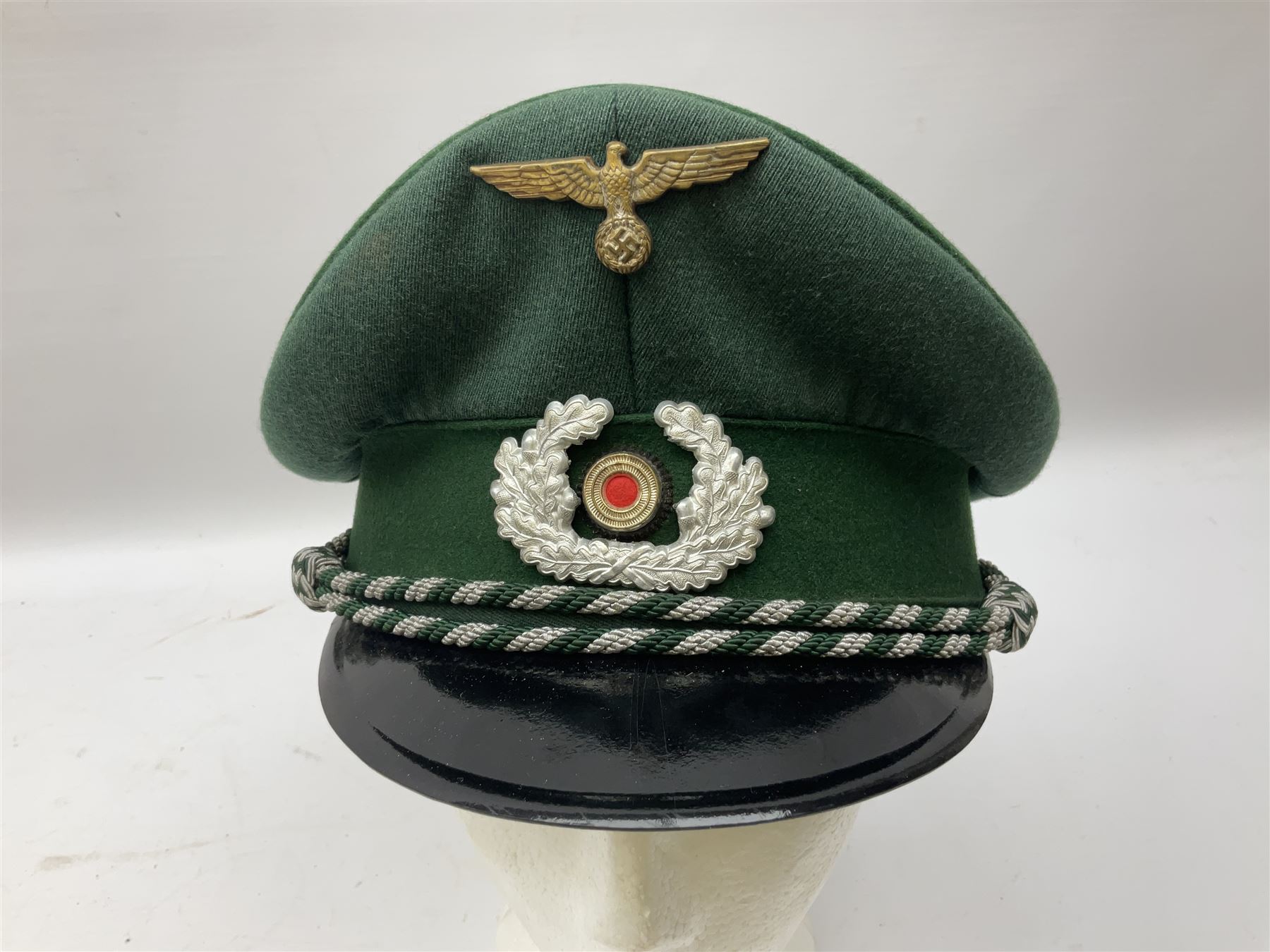 Five reproduction German WW2 hats comprising Wehrmacht olive tropical helmet, Heer officer's peaked cap, two M43 caps and Field side cap (5)