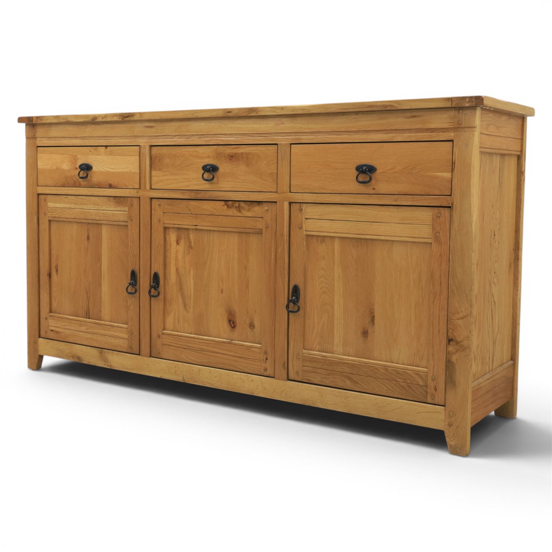 Contemporary oak sideboard, with rectangular top above three drawers and three cupboard doors, blackened metal handles, raised on stile supports