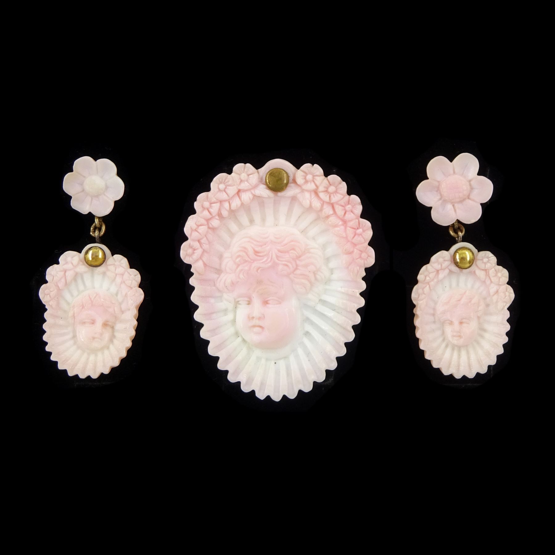 19th century gold conch shell pendant / brooch and matching earrings, each with carved bust shell of a cherub / child and flower head decoration, the earrings suspending a further flower head stud