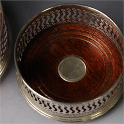 Two silver mounted bottle coasters, the larger example with latticework sides, hallmarked Mappin & Webb Ltd, Birmingham 1993, the smaller example with pierced sides, hallmarked W I Broadway & Co, Birmingham 1998, largest D12cm