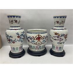Franklin Mint Chinese style ceramics, comprising two vases, puppy and a planter, all on wooden stands