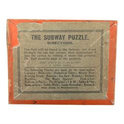 Early 20th century and later puzzles and games, including Bikee, 'A Novel and Very Amusing Game', by C.W. Faulkner & Co, Multum-In-Parvo Puzzle by RJ London, The Original 15 Puzzle by RJ London, The Chinese Zig-Zag 'A Wonderful and Extraordinary Puzzle', The Subway Puzzle by R Journet London, etc, all in glazed wooden display case