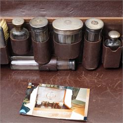  Leather dressing case with silver mounted brushes and glass bottles engraved with the Starkey crest W49cm London various dates circa 1930, Maker G H James & Co