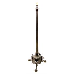 19th century heavy bronze floor standing lamp with traces of gilding, probably French, the urn shaped top on tapering reeded circular column, with central gadrooned dome to the base, supported on three bat-wing mounted paw feet