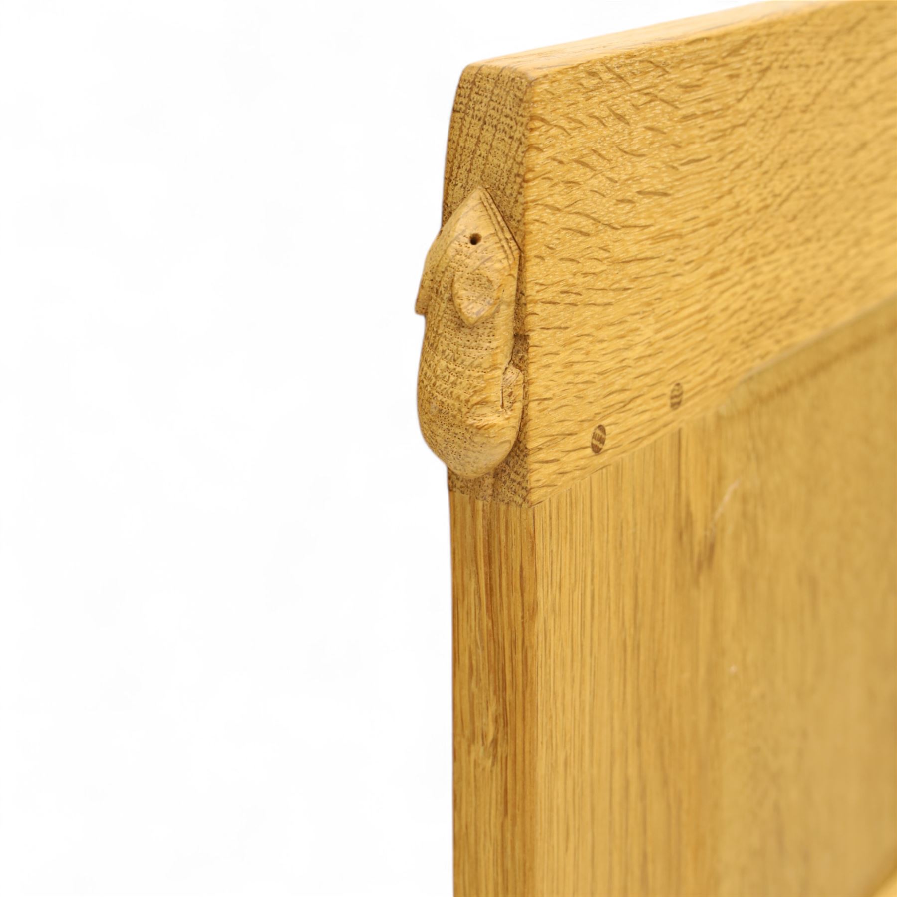 Mouseman - single bed oak headboard, comprising eight vertical fielded panels beneath a shaped and scalloped top rail, carved with the signature mouse motif, by the workshop of Robert Thompson, Kilburn 