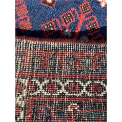 Persian Joshaghan crimson ground rug, stepped lozenge medallion surrounded by repeating foliate lozenge motifs, the border decorated with stylised plant motifs, within geometric guard stripes