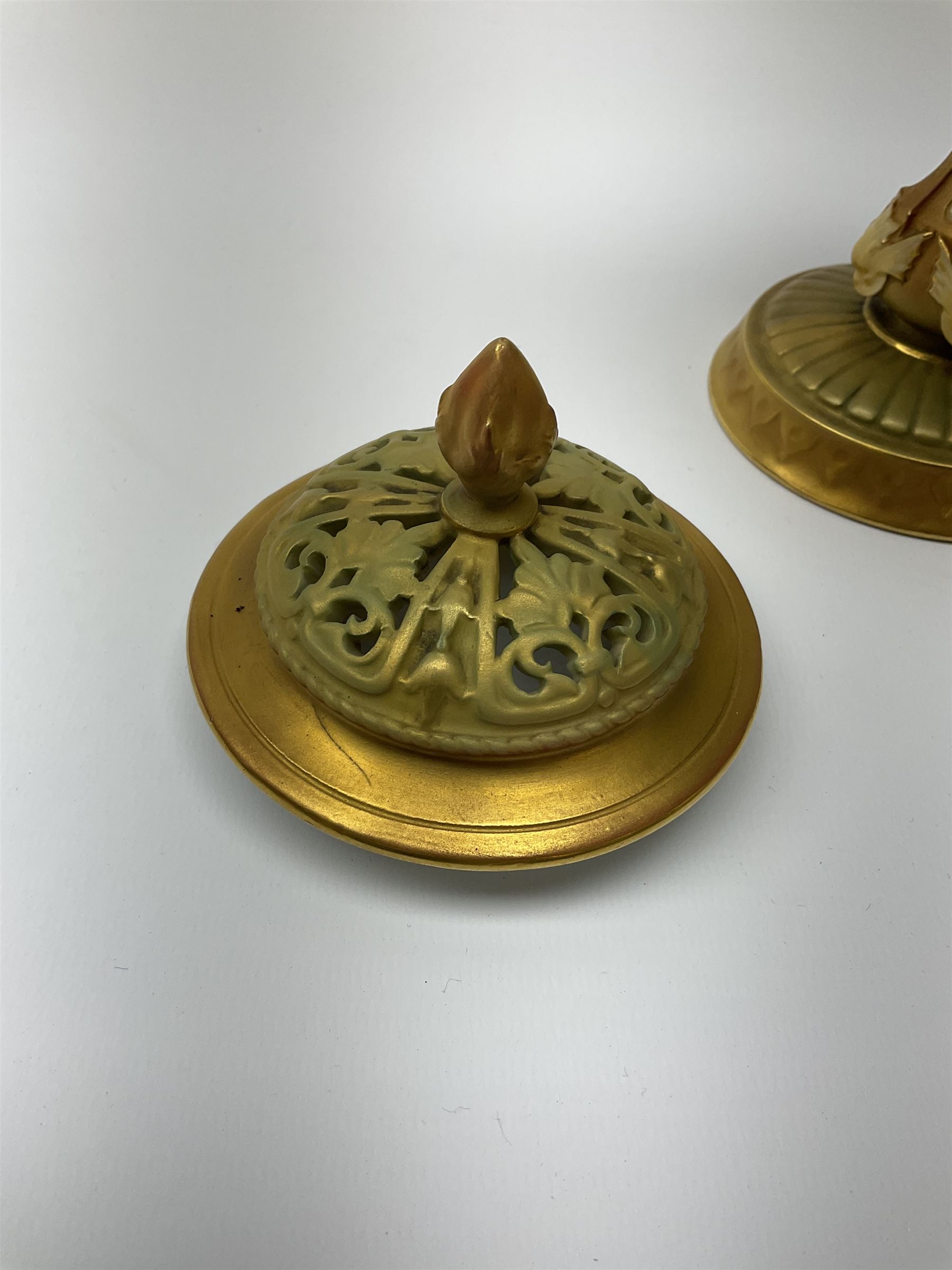 A Royal Worcester potpourri vase and cover, shape 1813, the bulbous body hand painted with pink roses and signed A Watkins, supporting a gilded and burnished pierced cover, upon a moulded stem with zoomorphic mask detail and circular foot, with puce printed mark beneath, H24cm