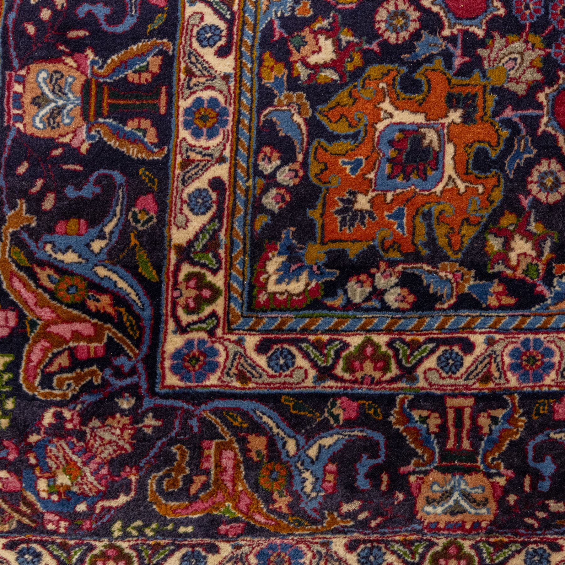 Persian Kashan wool carpet, red field centred with large floral medallion and conforming pendants, decorated with scrolling foliage and flowerheads, indigo spandrels and borders, from the region of Kashan