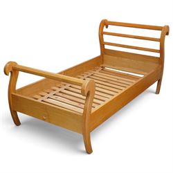 Unicornman - pair of craftsman-made oak single beds, of sleigh shape with scrolled head and foot-boards with octagonal stretchers, slatted base, raised on inward-splayed squared supports, applied with carved unicorn signature, by Geoff Gell of Coxwold