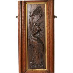 After Leander Plummer II, carved wooden panel of a stork amongst reeds, within a wooden frame, H80cm