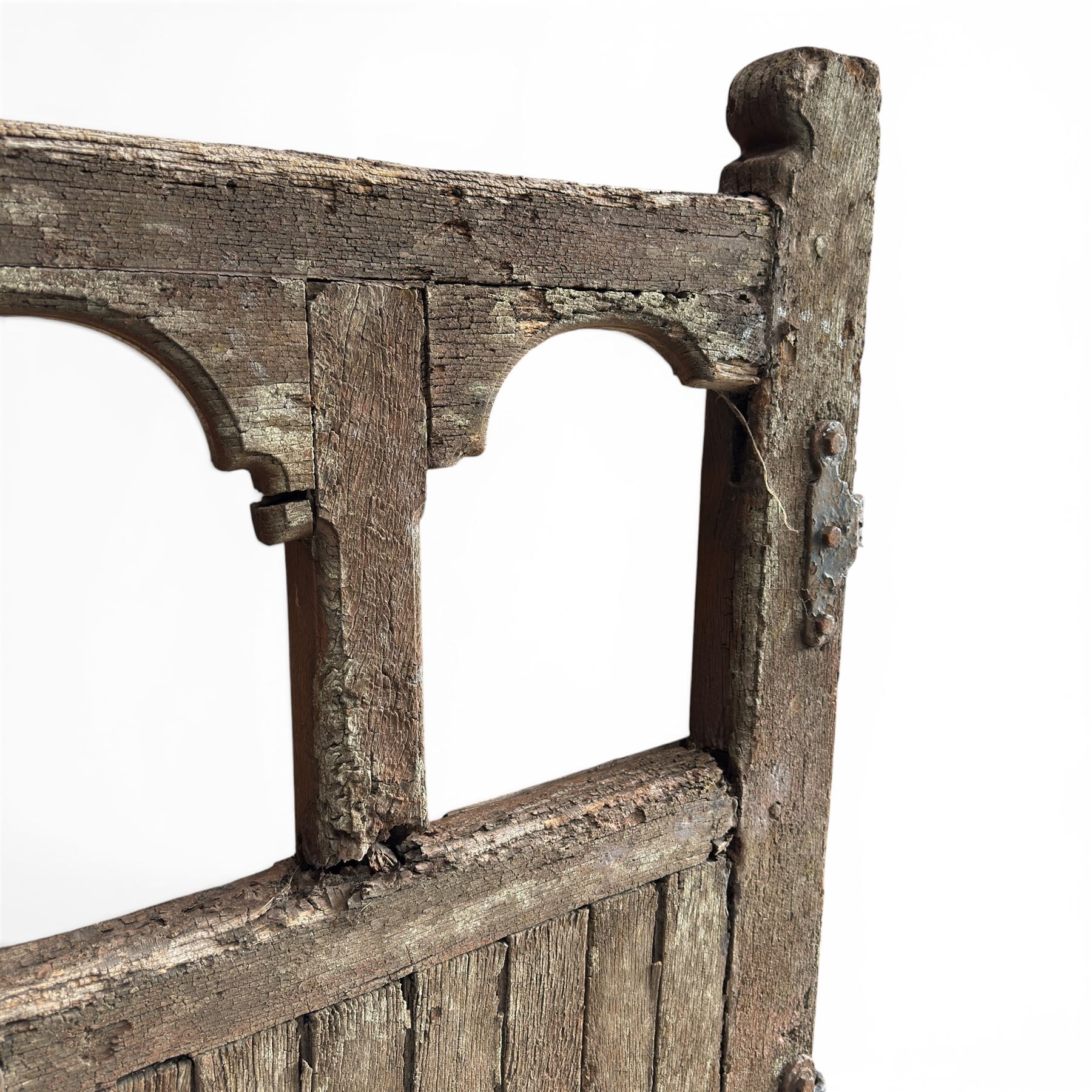 Pair of 19th century weathered wooden ecclesiastical church gates, the cresting rail over four pierced arches with slatted lower section, fitted with heavy cast iron hinges, latch and fittings