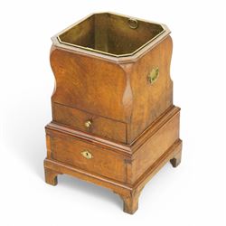 George III figured walnut champagne or wine cooler, of stepped square form with ogee cut-outs, fitted with two drawers, shaped handle plates with engraved decorated to each side, with brass liner, on bracket feet 