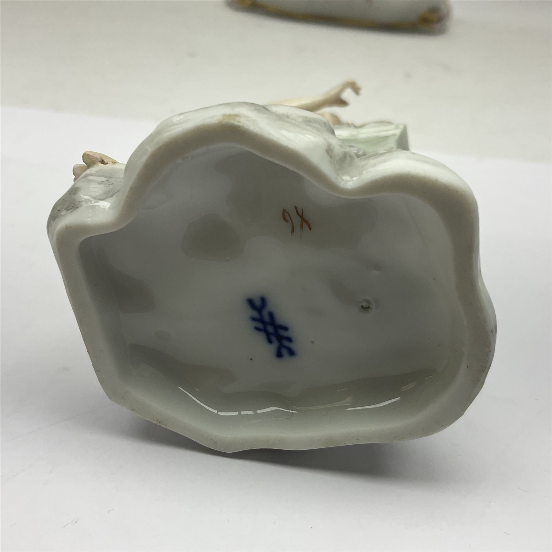 Three Continental figures, comprising a pair modelled as a boy and girl, she with flowers, he with eggs, and a female figure with harp, each probably Volkstedt, together with a Continental porcelain desk stand, (4)