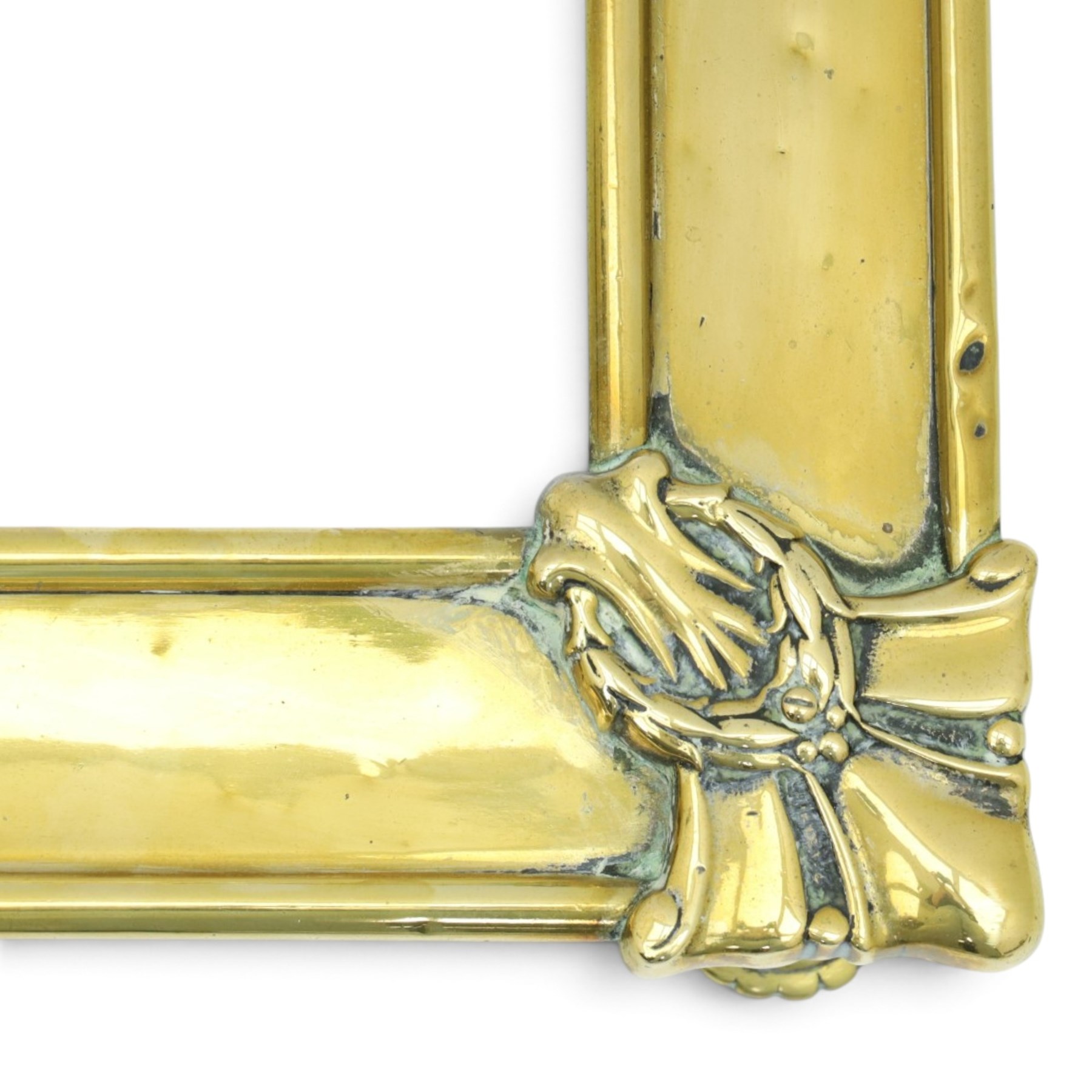 Two Edwardian brass fire curbs, comprising a decorative example with pierced vertical frieze, applied Tulips (H 21cm, W 126cm, D 32cm), together with a hammered moulded example with acanthus corners (H 12cm, W 138cm, D 37cm)