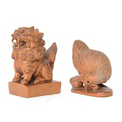  Two wooden netsuke, in the forms of a foo dog and a chicken, both signed to the base, H6cm