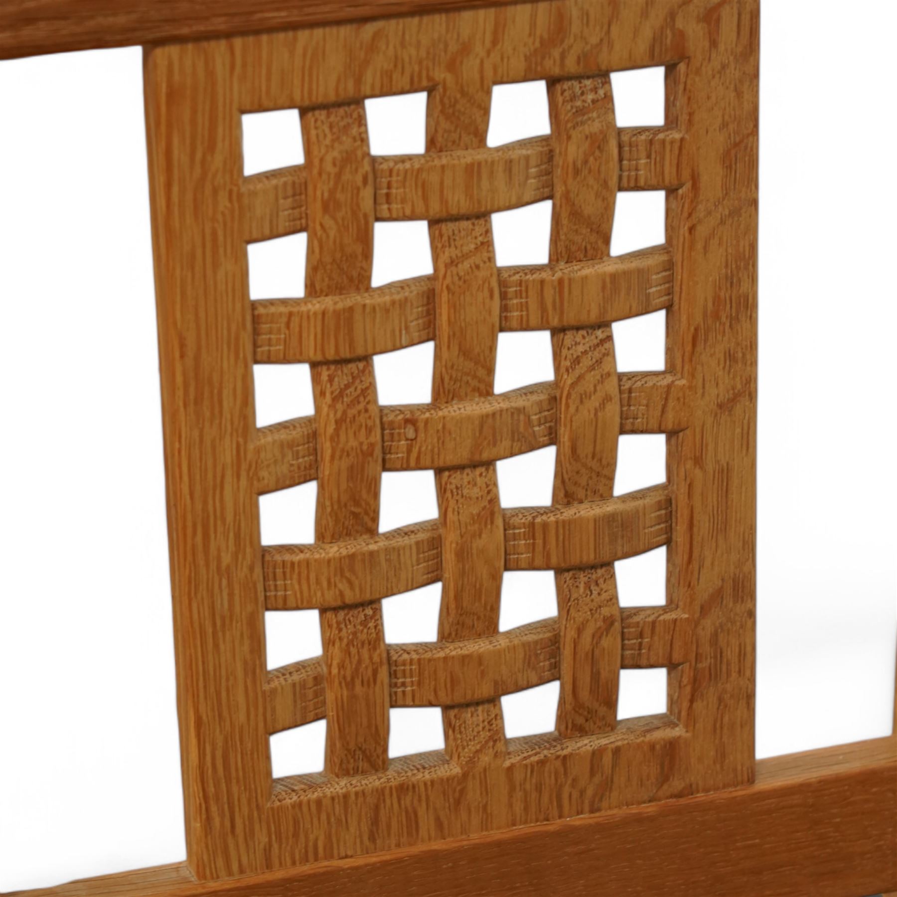 Mouseman - set of six oak dining chairs, pierced and carved lattice back over leather upholstered seat, on octagonal front supports united by stretchers, carved with mouse signature, by the workshop of Robert Thompson, Kilburn 