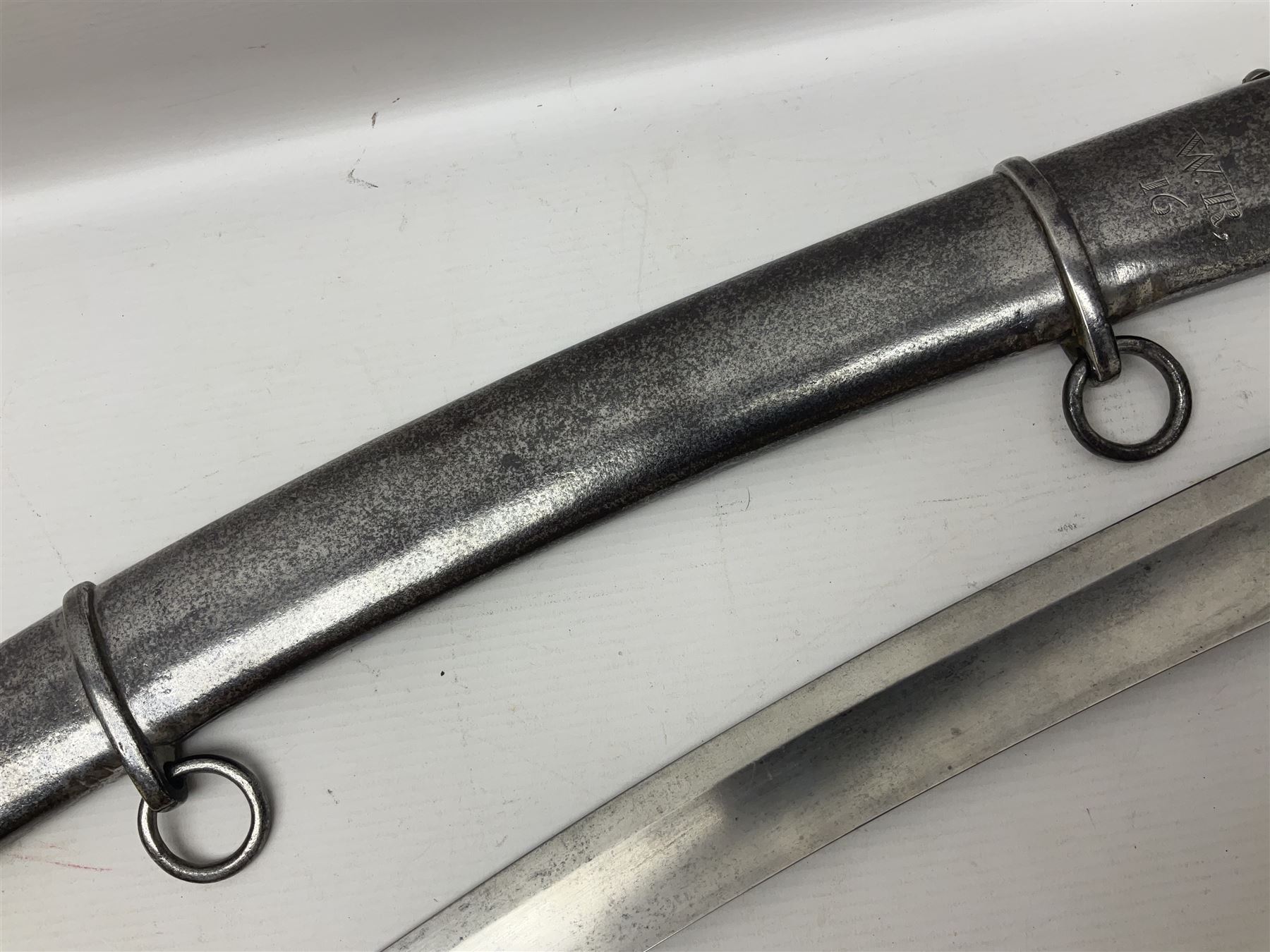 British 1796 Pattern Light Cavalry trooper's sword, the 84cm curving fullered blade stamped Hadley.1 to the back edge, steel hilt with knucklebow, D-shaped langets and leather grip; in polished steel scabbard stamped Osborn & Gunby Birmm. and W.R.16 ( ?16th Light Dragoons) with two suspension rings L100cm overall