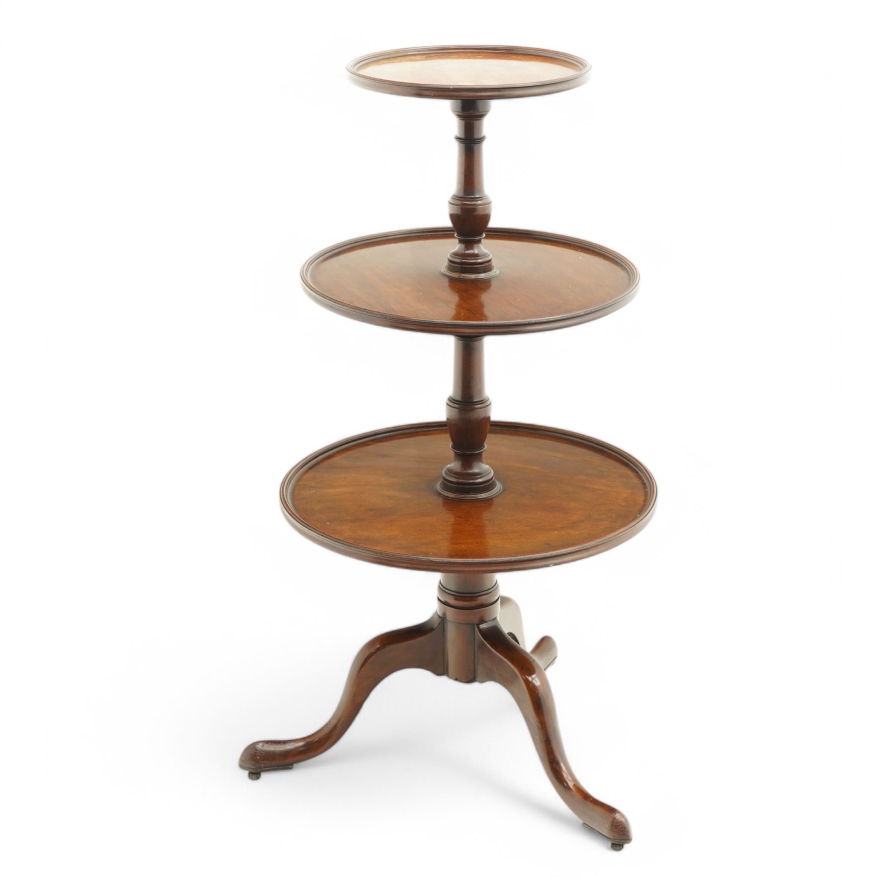 George III mahogany dumb waiter, three graduating circular tiers with moulded edges, turned column supports on tripod base, on castors 