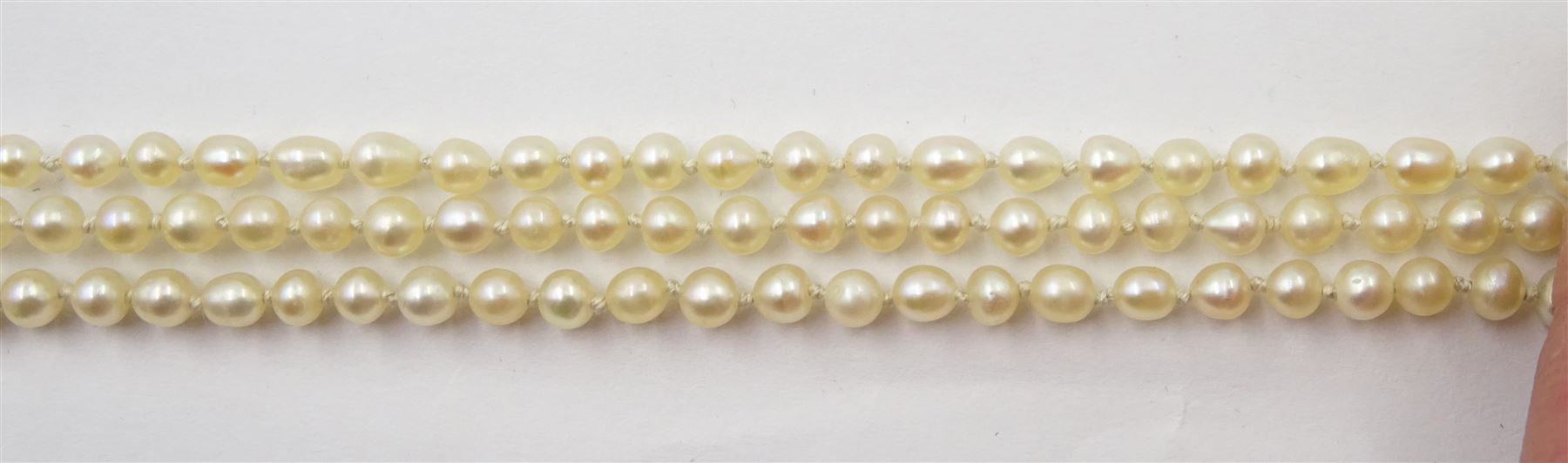 Three strand pearl necklace, with platinum diamond milgrain clasp and a single strand graduating pearl necklace with 18ct white gold clasp set with a diamond