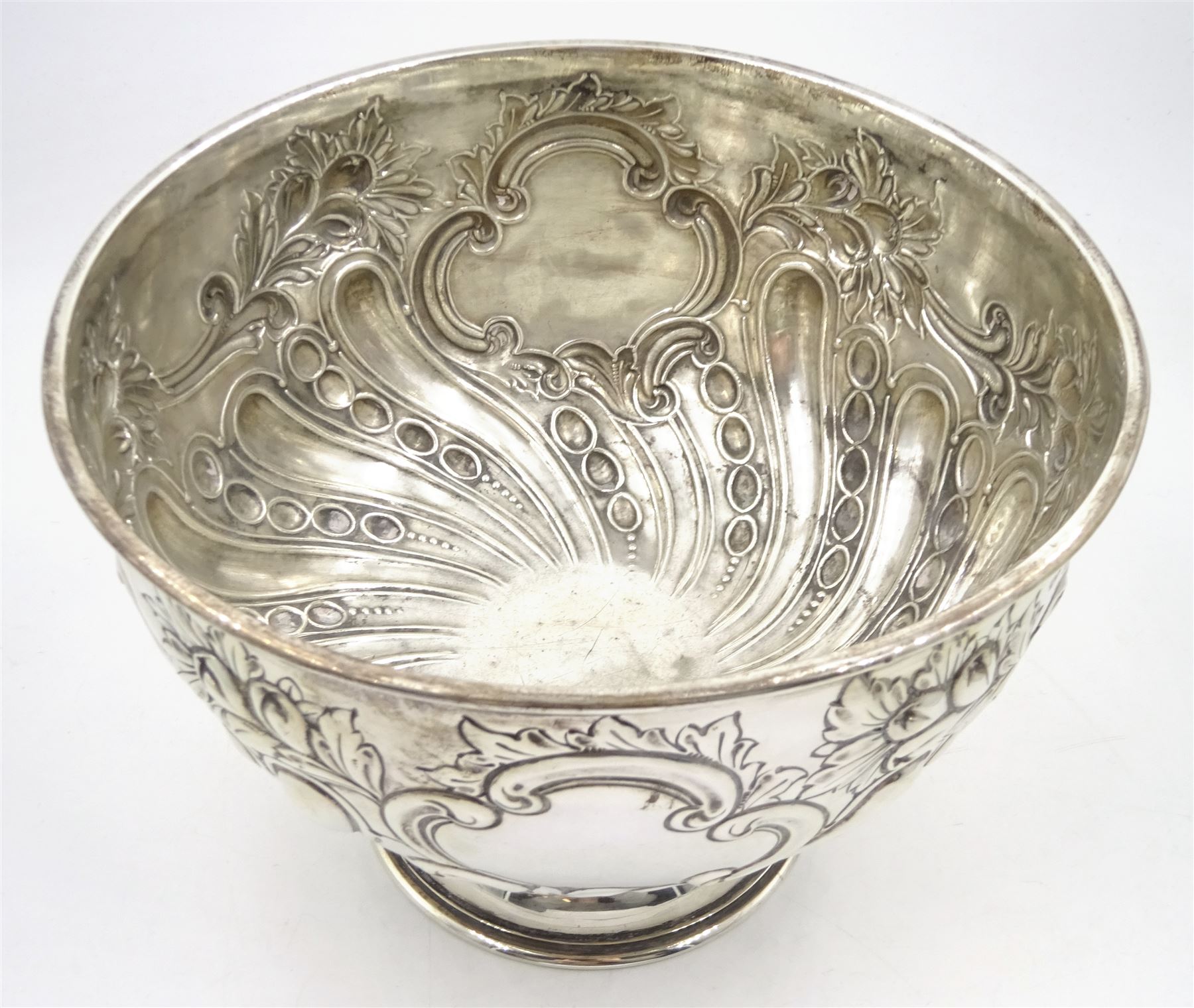 Edwardian silver rose bowl, the part fluted bowl embossed with acanthus leaves, flower heads and C scrolls and personally engraving 'S.S Rievaulx Abbey - Built By - Earle's Shipbuilding & Engineering Co Ltd - For The - Hull & Netherlands Steamship Co. Limited Launched December 23rd 1907', upon a spreading circular foot, hallmarked F Boyton & Co, London 1905, H14.5cm, D20.5cm, approximate weight 17.34 ozt (539.6 grams)