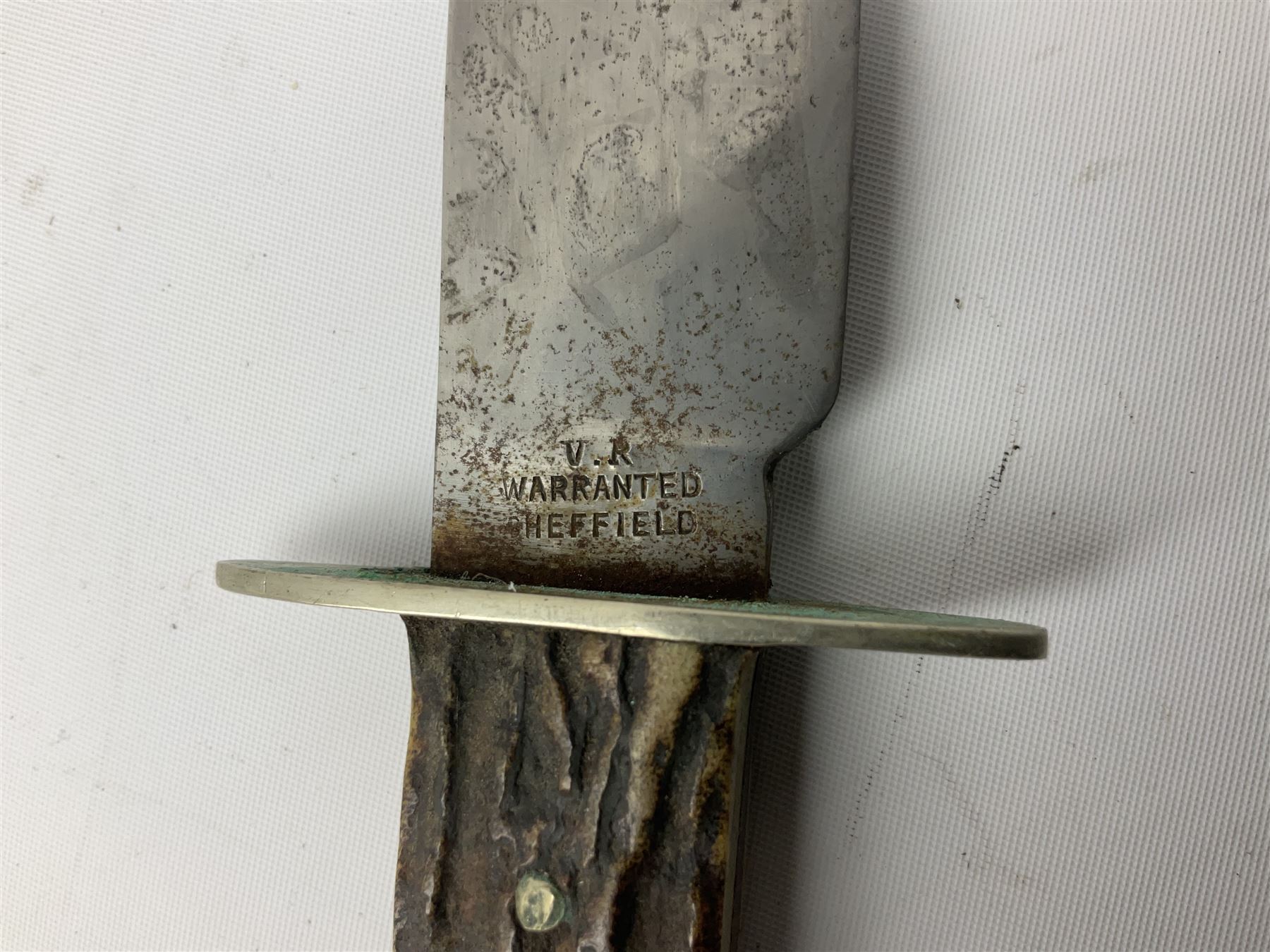 Hunting knife by J Nowill & Sons, Sheffield, the handle inset with mother of pearl, blade length 19cm; George Wolstenholme IXL lock-knife with antler scales L29cm open; and another Bowie style hunting knife marked 'V.R. Warranted Sheffield Joseph Ellis & Sons' in leather sheath (3)