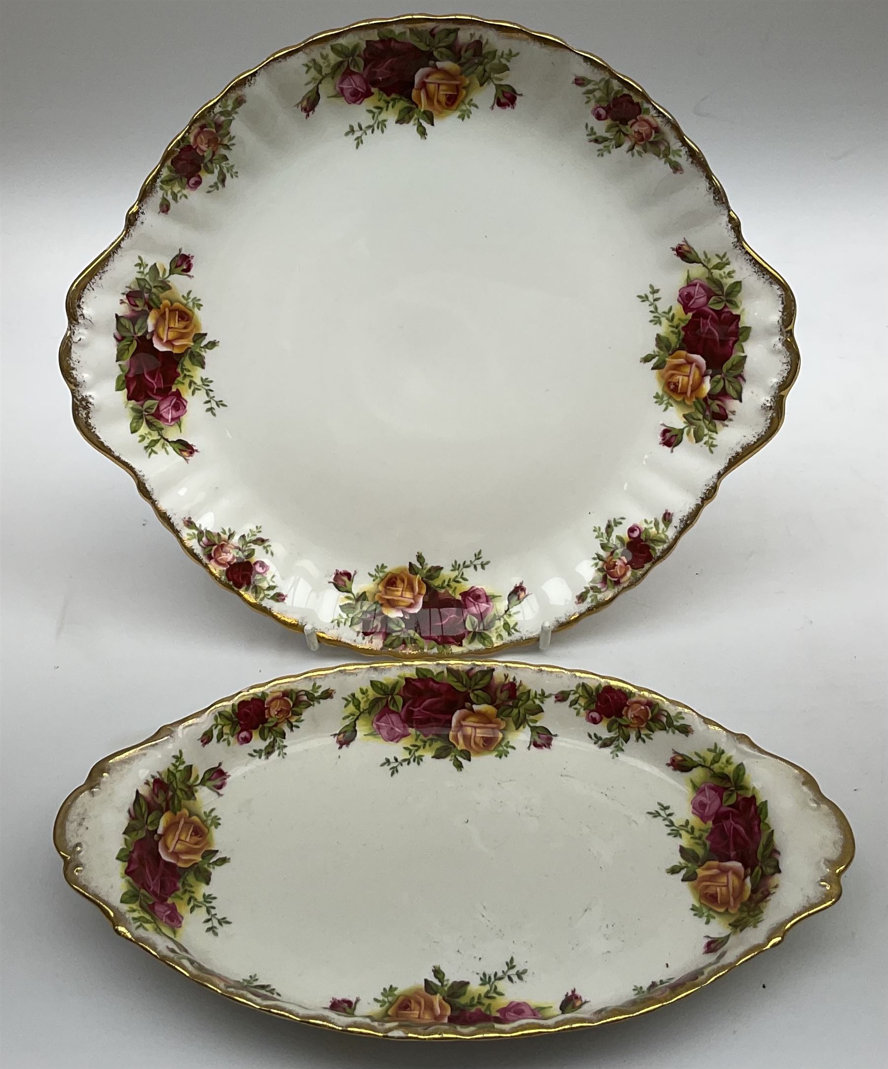 Royal Albert Old Country Roses part dinner and tea service comprising teapot, four tea cups and saucers, eight dessert plates, cake plate, cake stand, a tureen with cover, six dinner plates, an oval dish, two trinket dishes, bell and shoe decoration. 