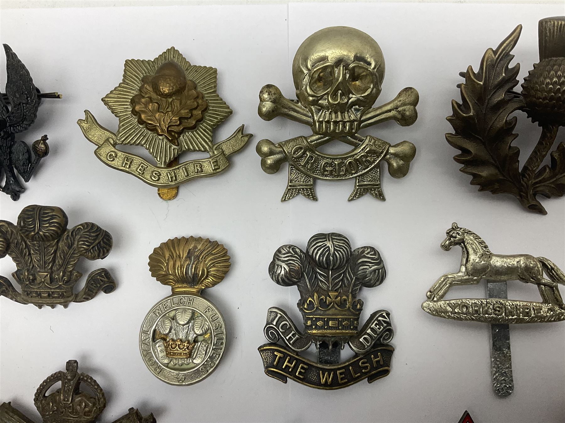 Two Edwardian hallmarked silver presentation fobs for military bugling competitions; and quantity of cap/glengarry and other badges, sweetheart brooches etc